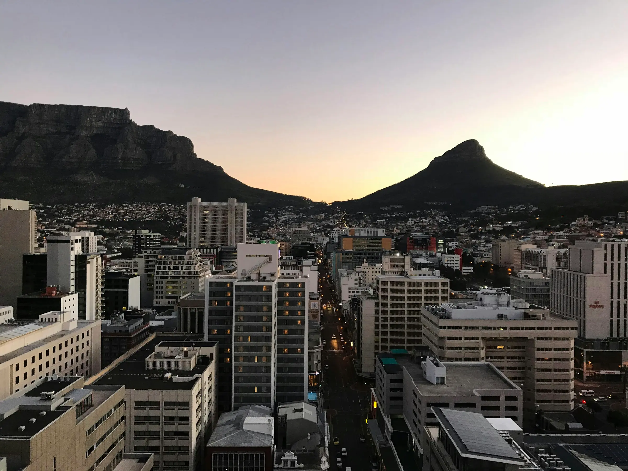 Cape Town city centre at dusk beneath Table Mountain and Lion's Head